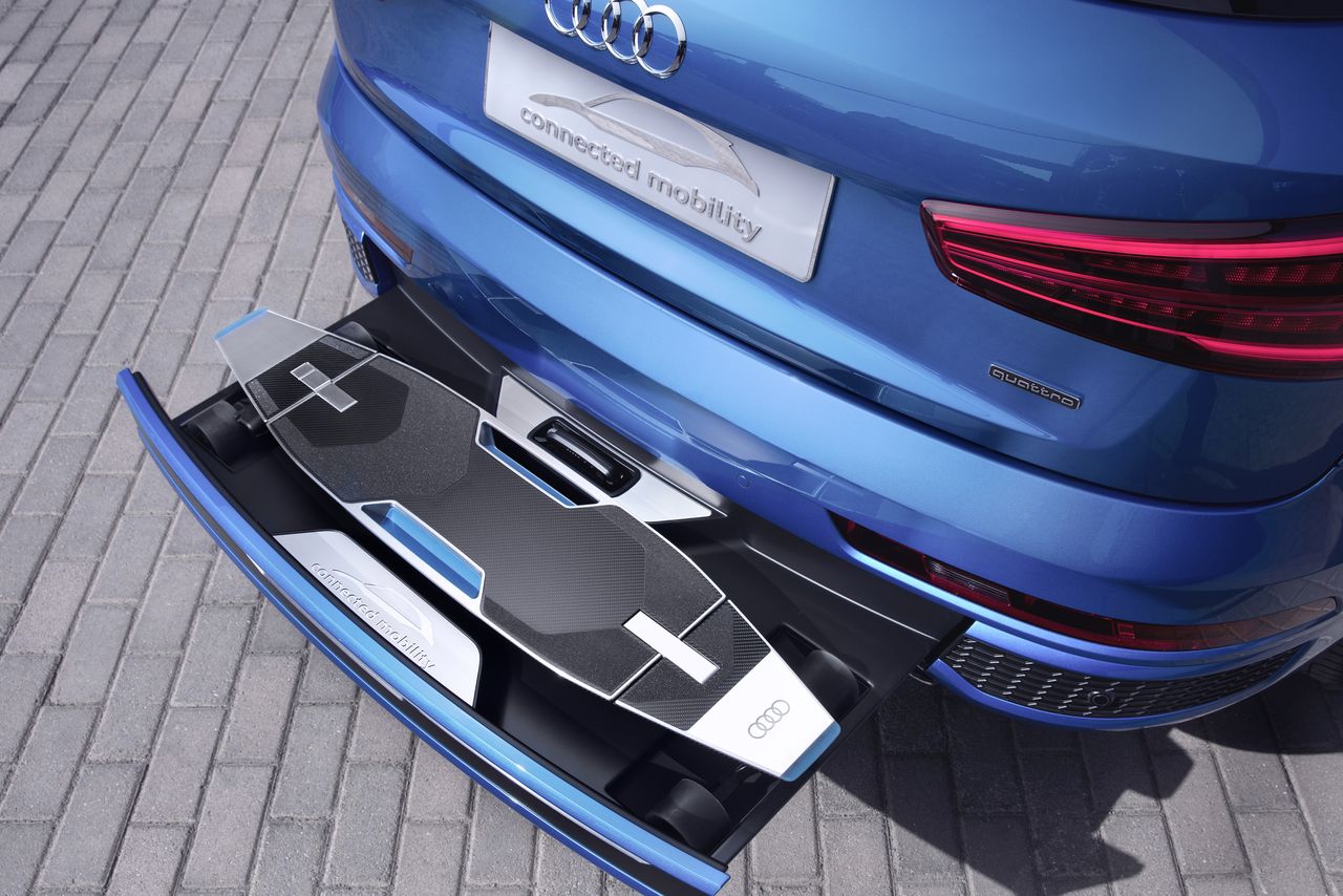 This Audi has a beautiful electric longboard hidden in its bumper